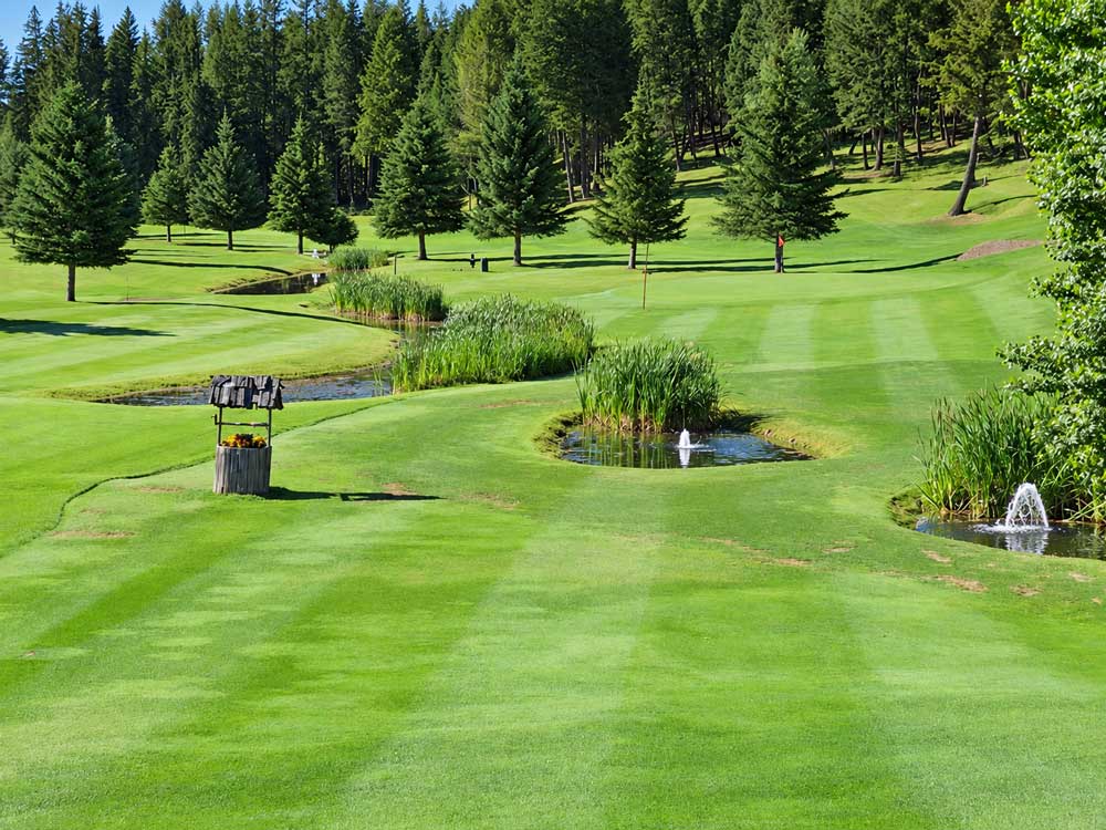 Serene Golf Course With Ponds And Fountains